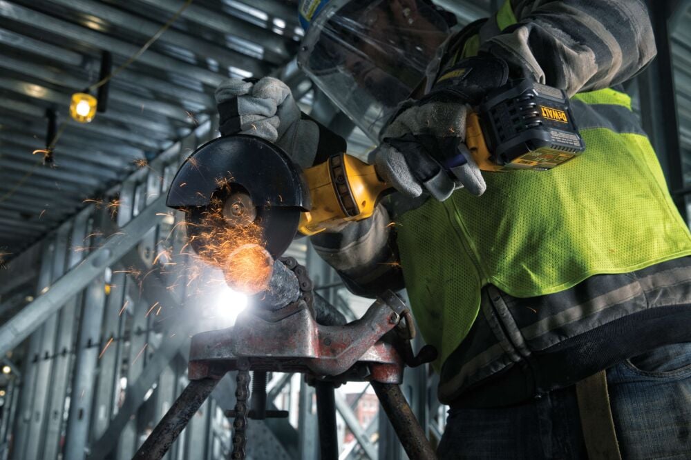 profile of GRINDER 1 BATTERY with an abrasive wheel attachment in action