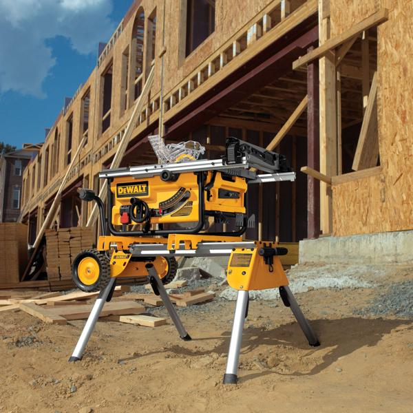 Rolling table saw stand in a project workplace with tools on top.