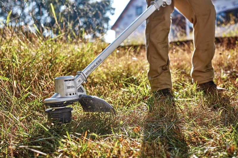 Folding String Trimmer in action on grass.