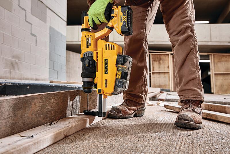 Dust extractor drilling wooden wooden plank.