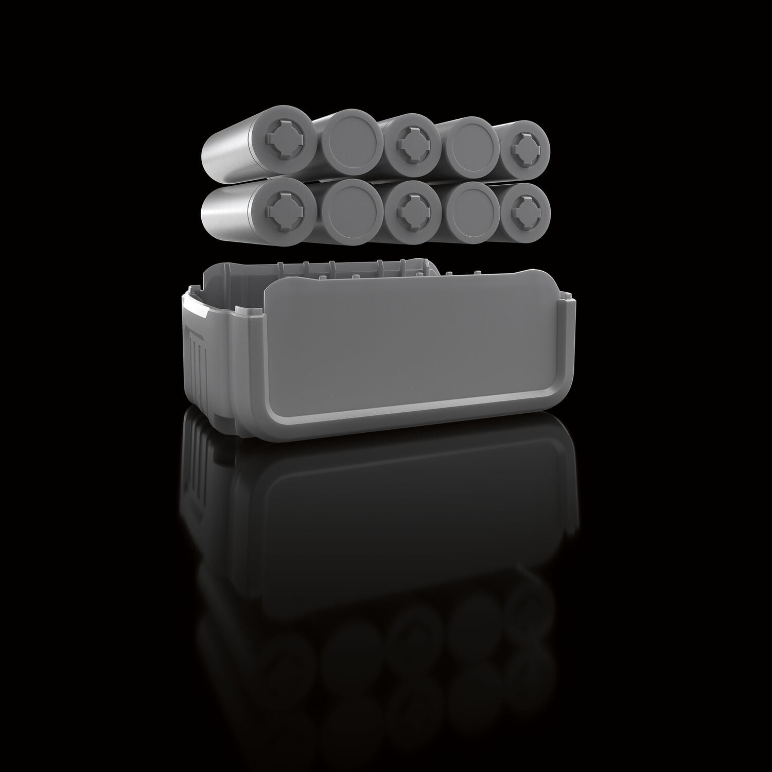 Una representación en 3D de un paquete de baterías con celdas cilíndricas sobre una carcasa de batería abierta, mostrado sobre una superficie negra reflectante.